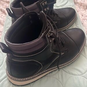 One pair of black mens boot. White and black base.